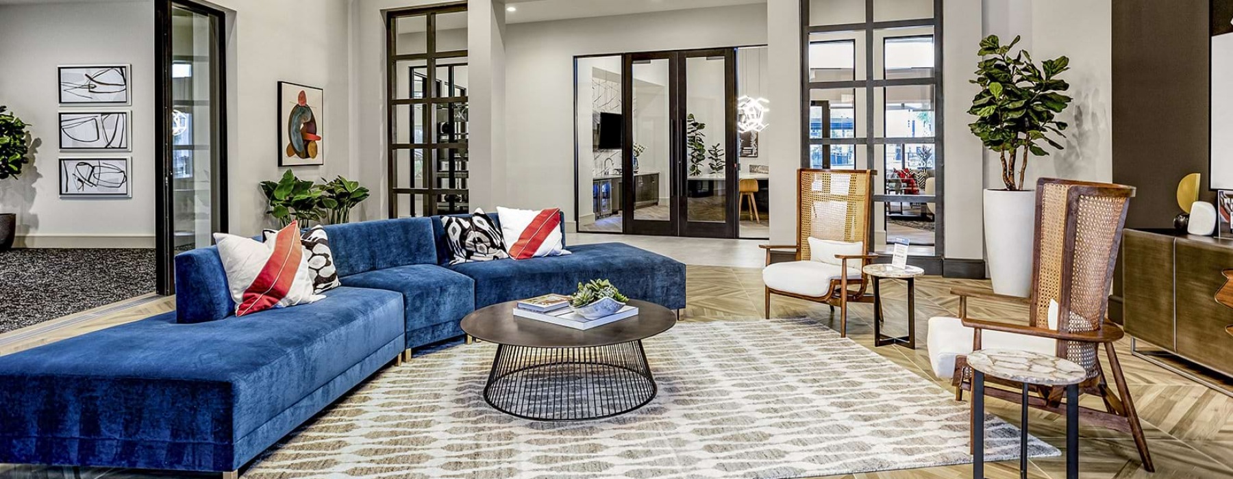 Spacious and well lit lounge with large windows and plenty of seating 